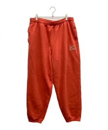 NIKE×stussy（ナイキ×ステューシー）の古着「スウェットパンツ」｜オレンジ