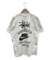 stussy（ステューシー）の古着「コラボTシャツ The Wide World Tribe」｜ホワイト