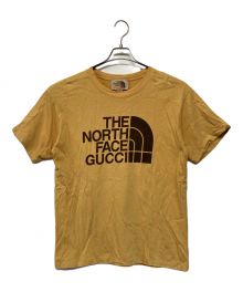 THE NORTH FACE×GUCCI（ザ ノース フェイス×グッチ）の古着「ダブルネームロゴプリントTシャツ」｜マスタード×ブラウン