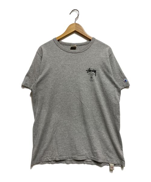 stussy（ステューシー）stussy (ステューシー) Champion (チャンピオン) スカルウィングプリントＴシャツ グレー サイズ:Мの古着・服飾アイテム