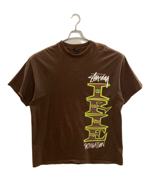 stussy（ステューシー）stussy (ステューシー) IRIE SENSATION プリントTシャツ ブラウン サイズ:XLの古着・服飾アイテム