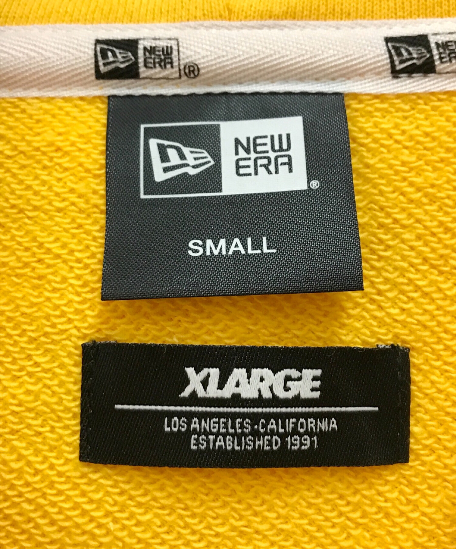 New Era × XLARGE × NBA (ニューエラ × エクストララージ × エヌビーエー) プルオーバーパーカー イエロー サイズ:S